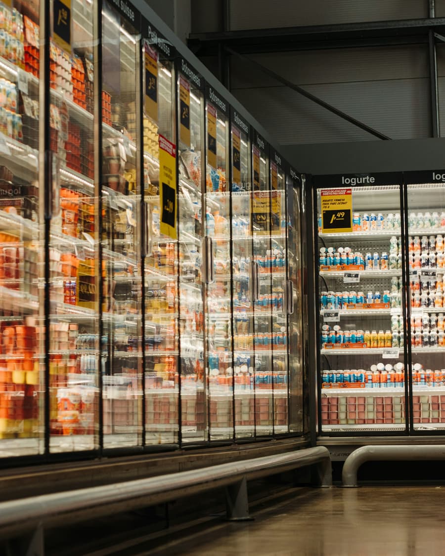 Refrigerated display cases lined with yoghurt in a grocery store