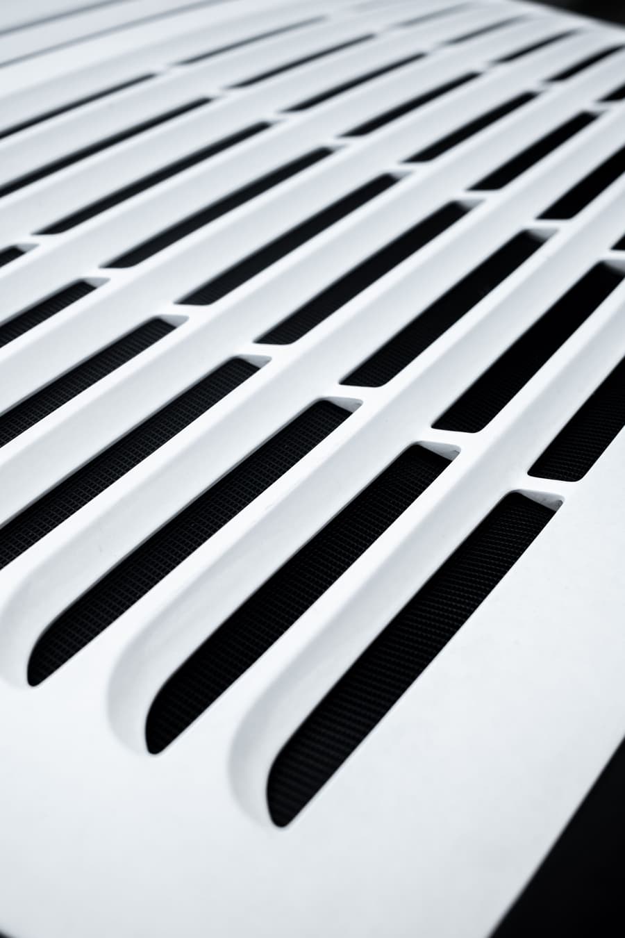 Close-up of a white slotted ceiling vent