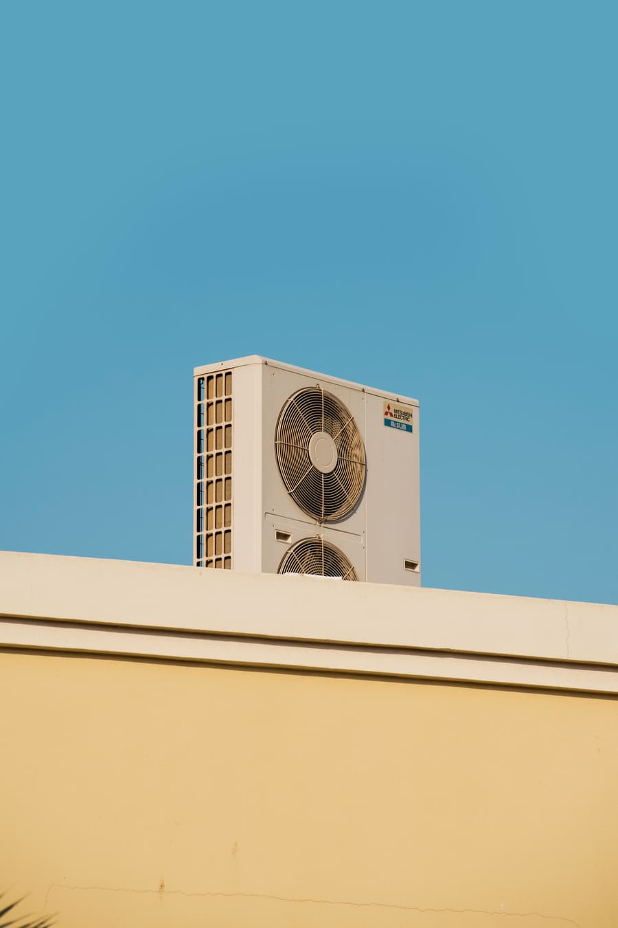 Outdoor condensing unit on a flat roof against blue sky