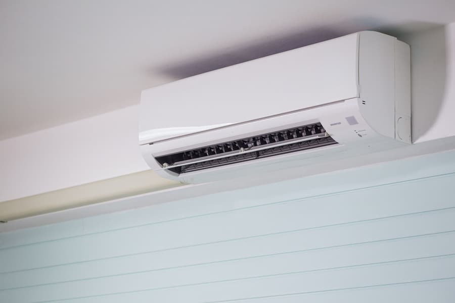 White split system head high on a plain living room wall