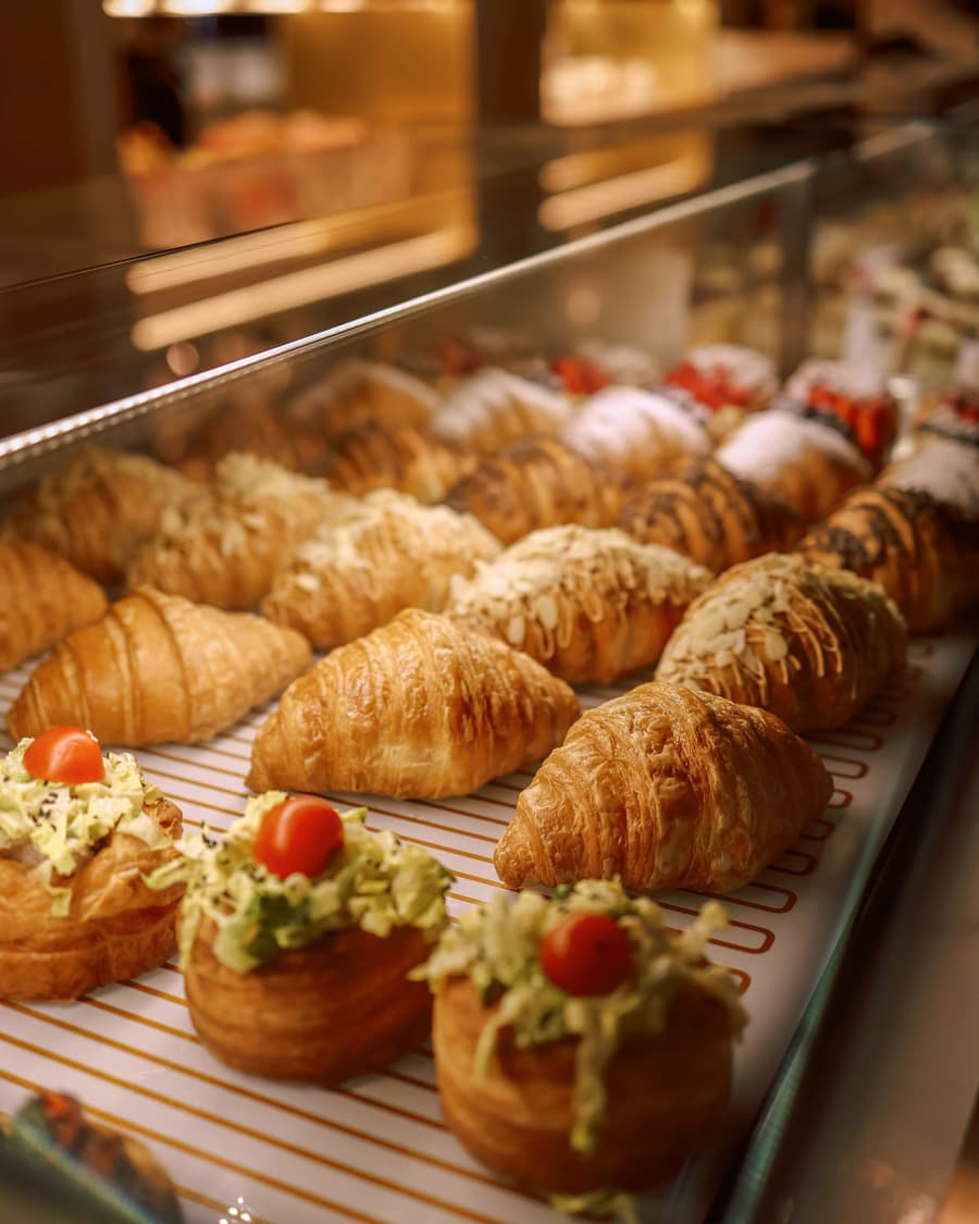 Refrigerated display case of pastries under glass in a bakery