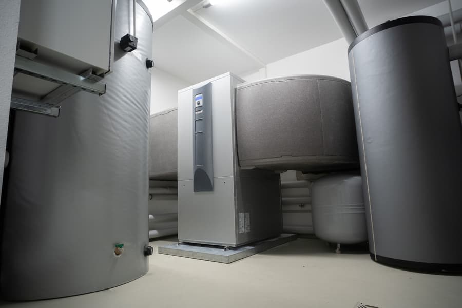 Hot water heat pump cylinders in a clean grey plant room